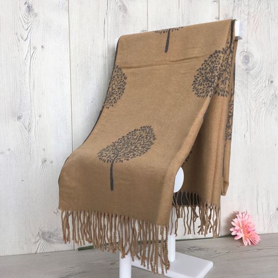 Cashmere Winter Scarf with a tree design and tassels on a display stand. Camel