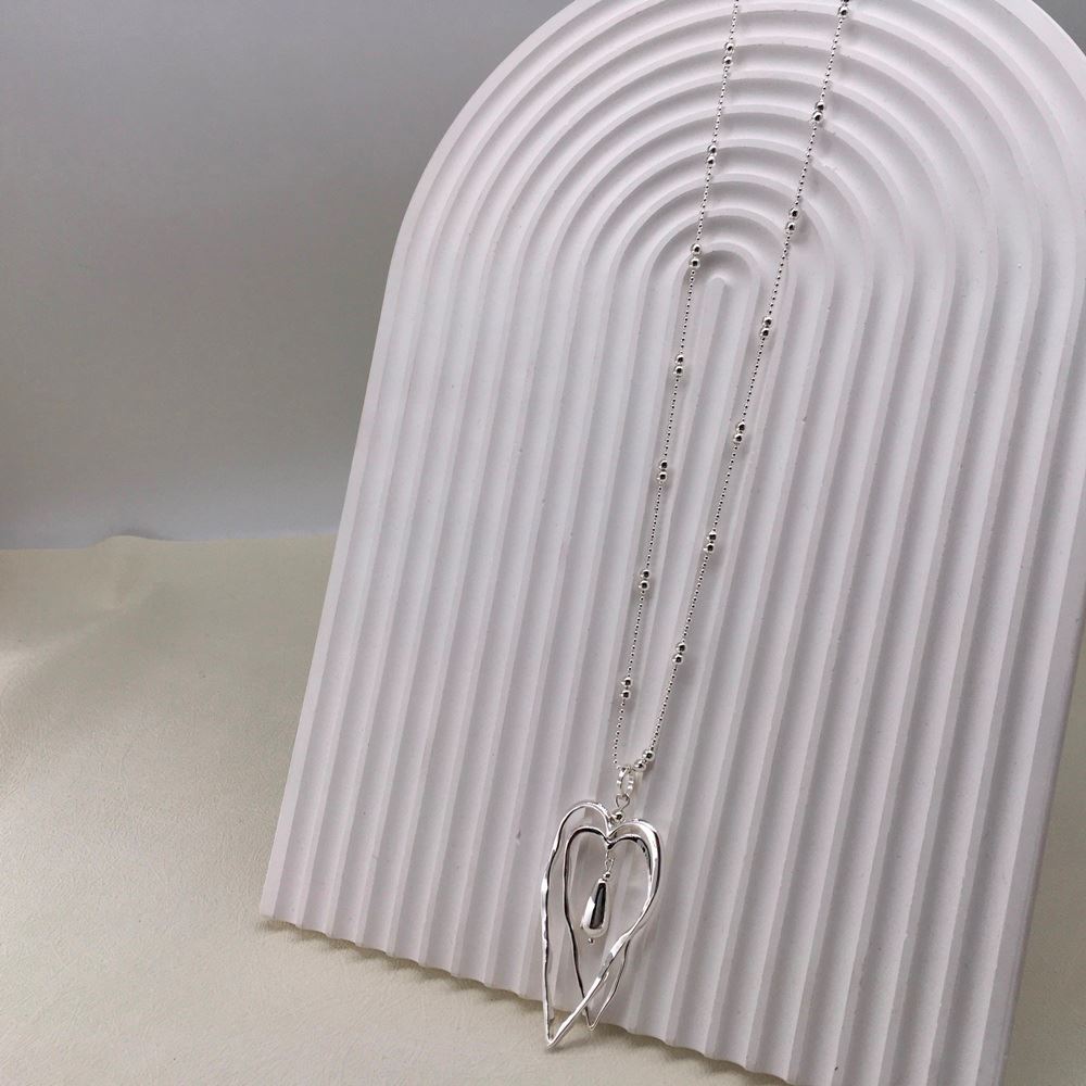Double Heart Necklace on a display stand.