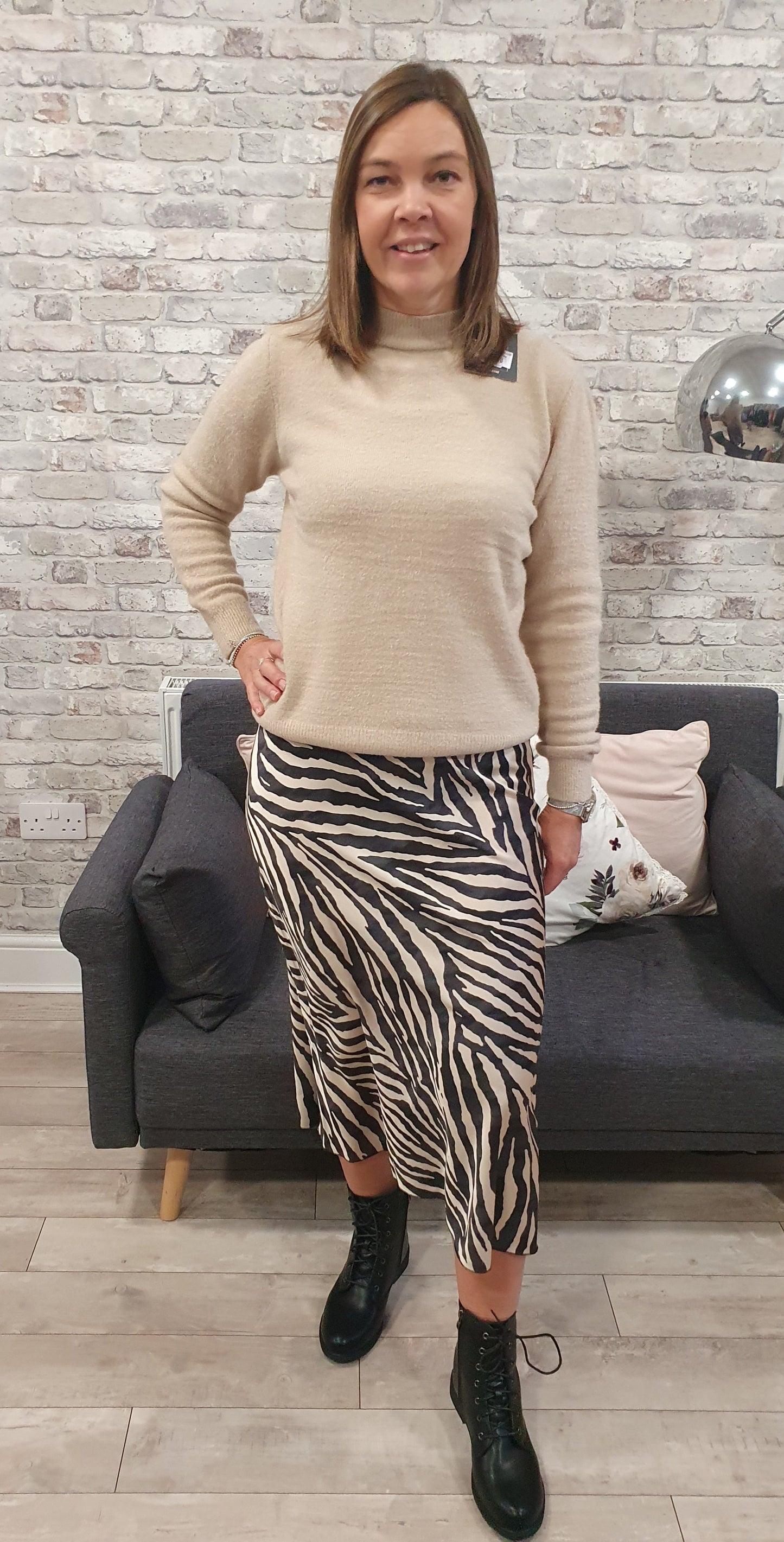Animal print satin skirt with a zebra pattern, worn by a person pairing it with a beige top.