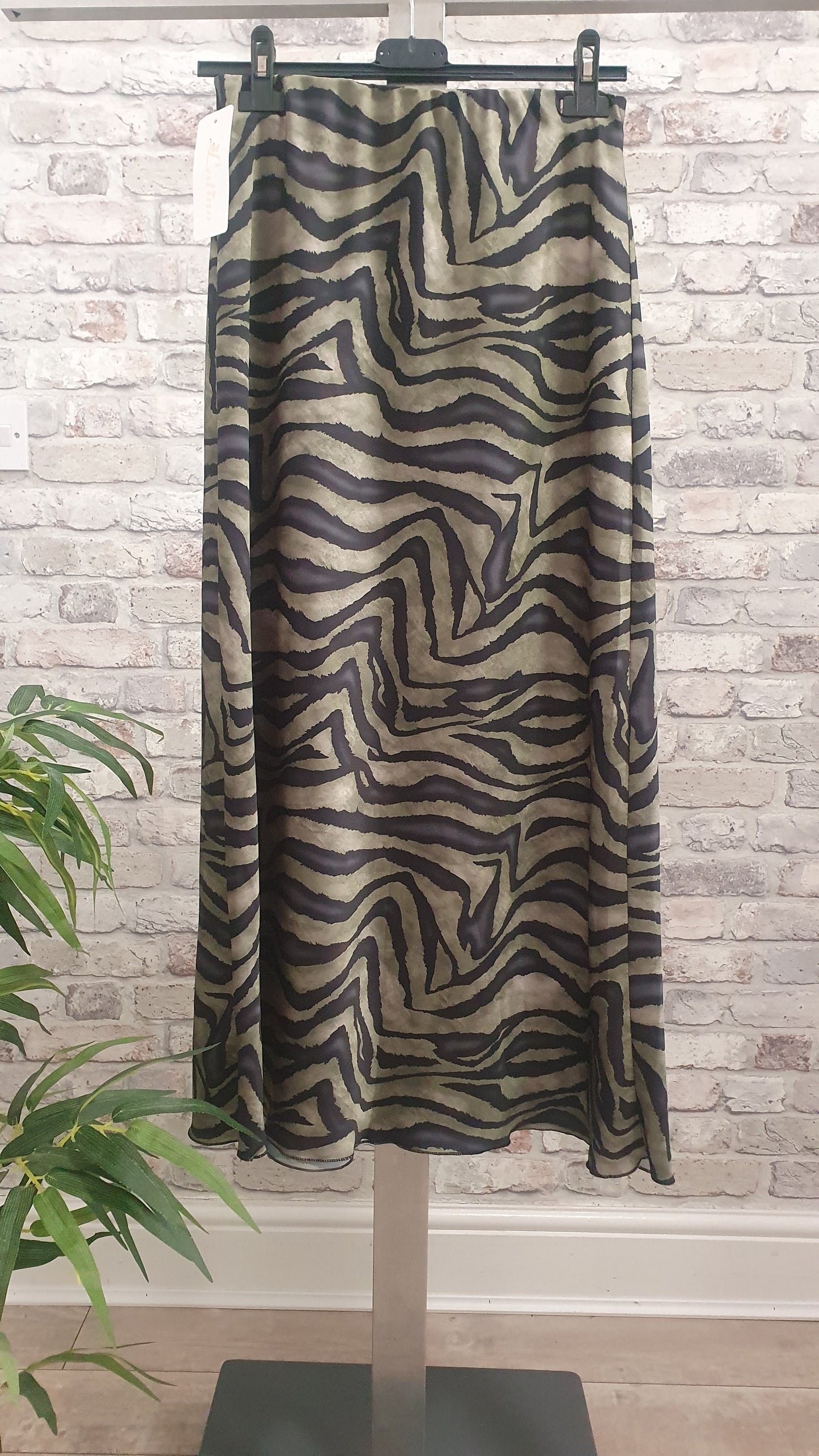 Animal print satin midi skirt with elegant design and luxurious feel.