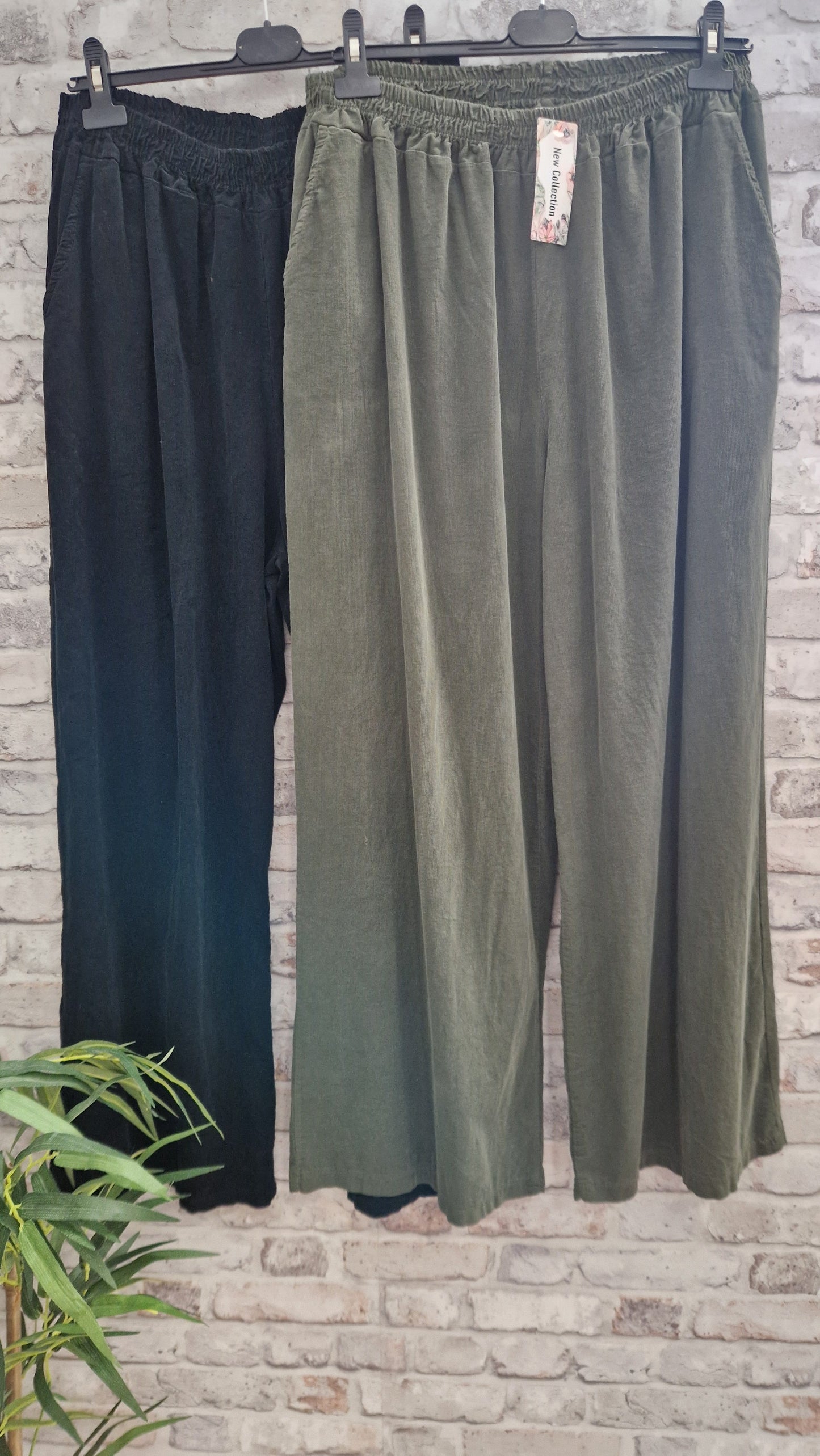 Cord wide leg trousers with side pockets, made from 100% cotton, available in black and green.