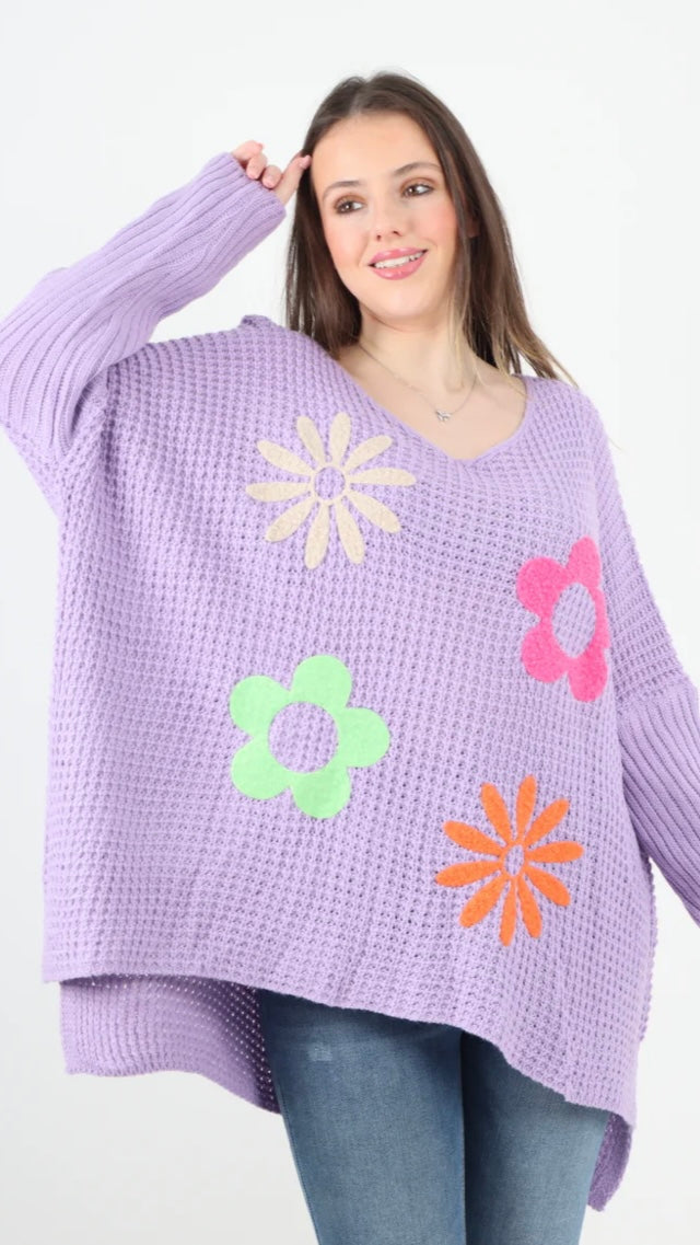 Side slit floral jumper in purple with colorful flower designs.
