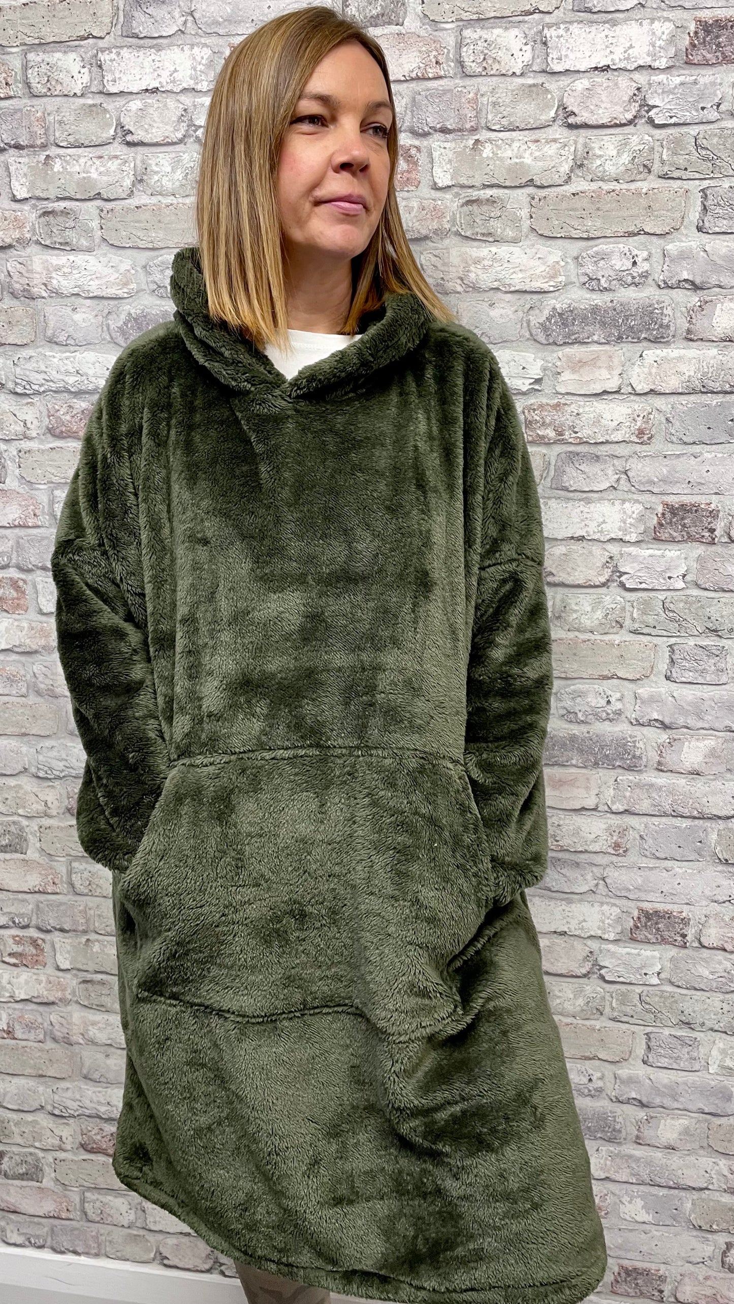 Unisex Blanket Hoodie with hood and front pocket, olive green, soft polyester fabric.