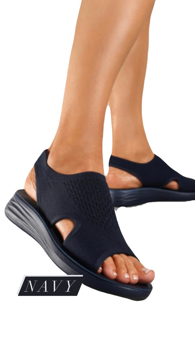 Lightweight Comfort Sandal with navy fabric and modern sole design.