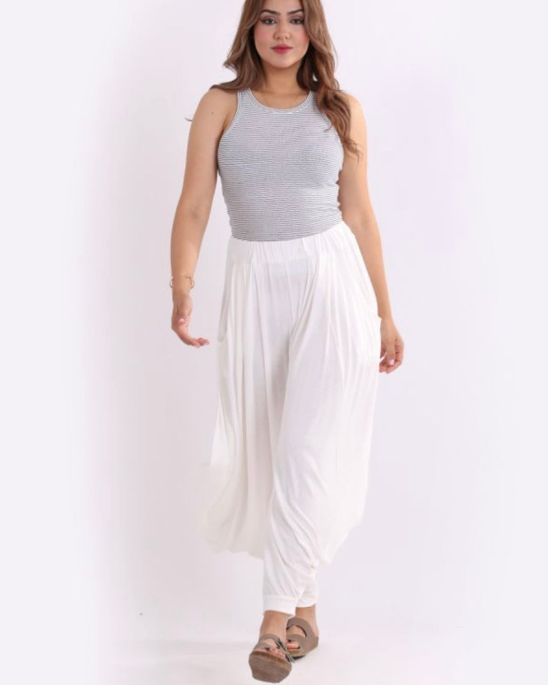 Woman wearing Italian Jersey Harem pants with elasticated waist and side pockets.