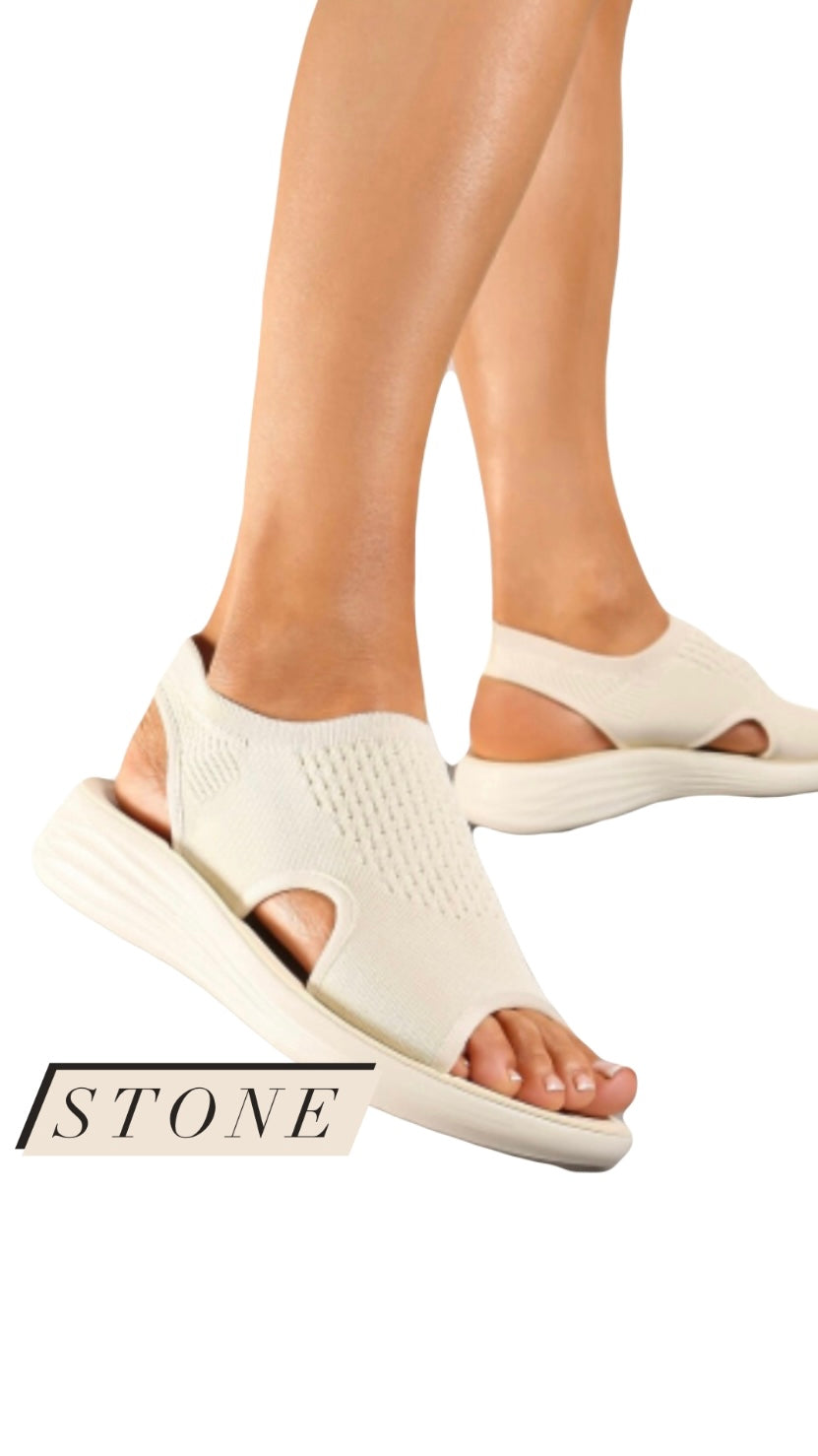 Lightweight comfort sandal with fabric design and light sole.