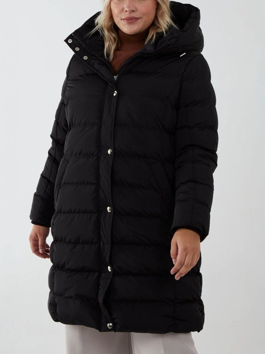 Longline Puffer Jacket in black, warm and wind-resistant, 100% polyester.