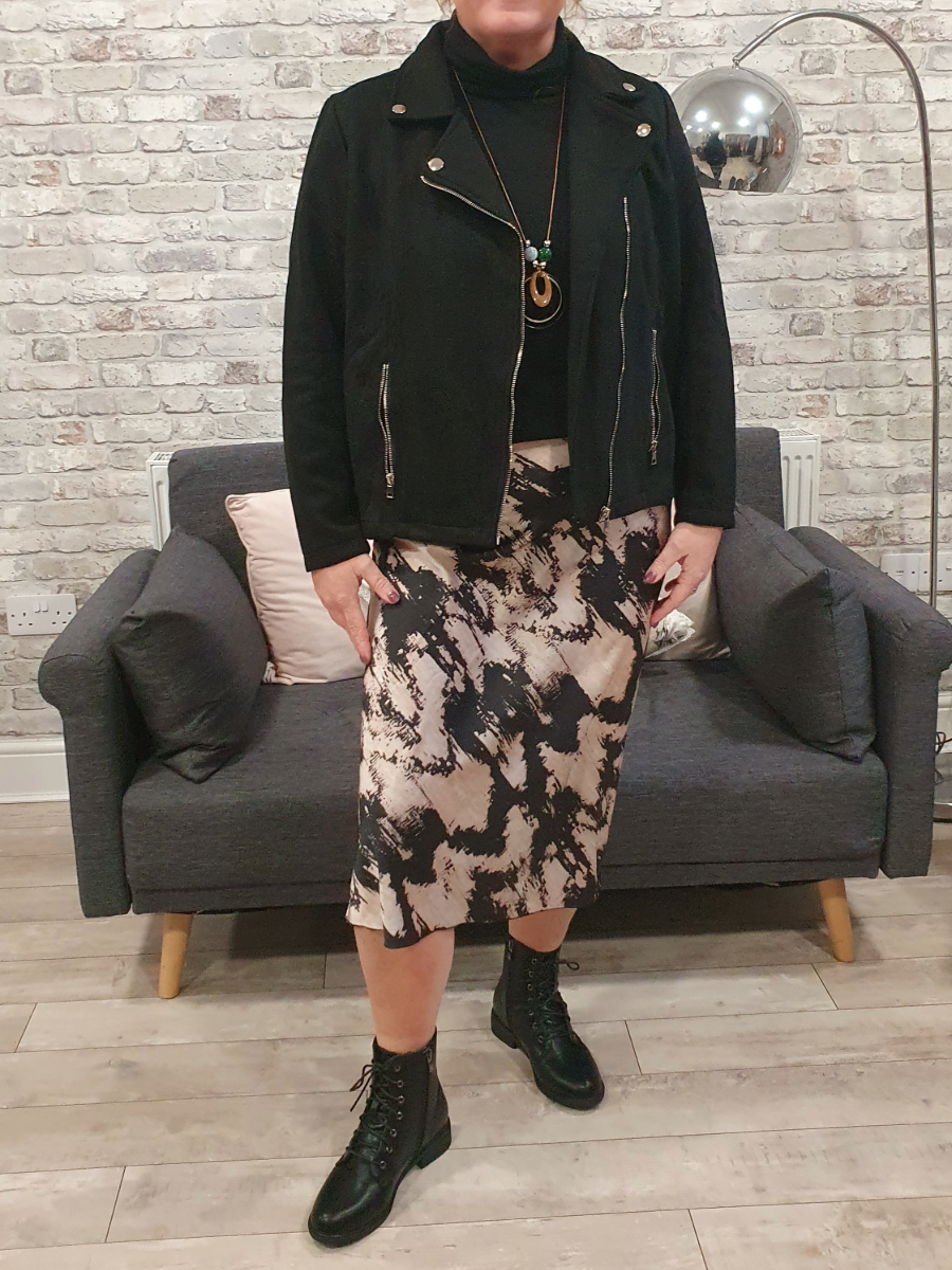 Splash Pattern Satin Skirt made of 100% polyester, styled with a black jacket.