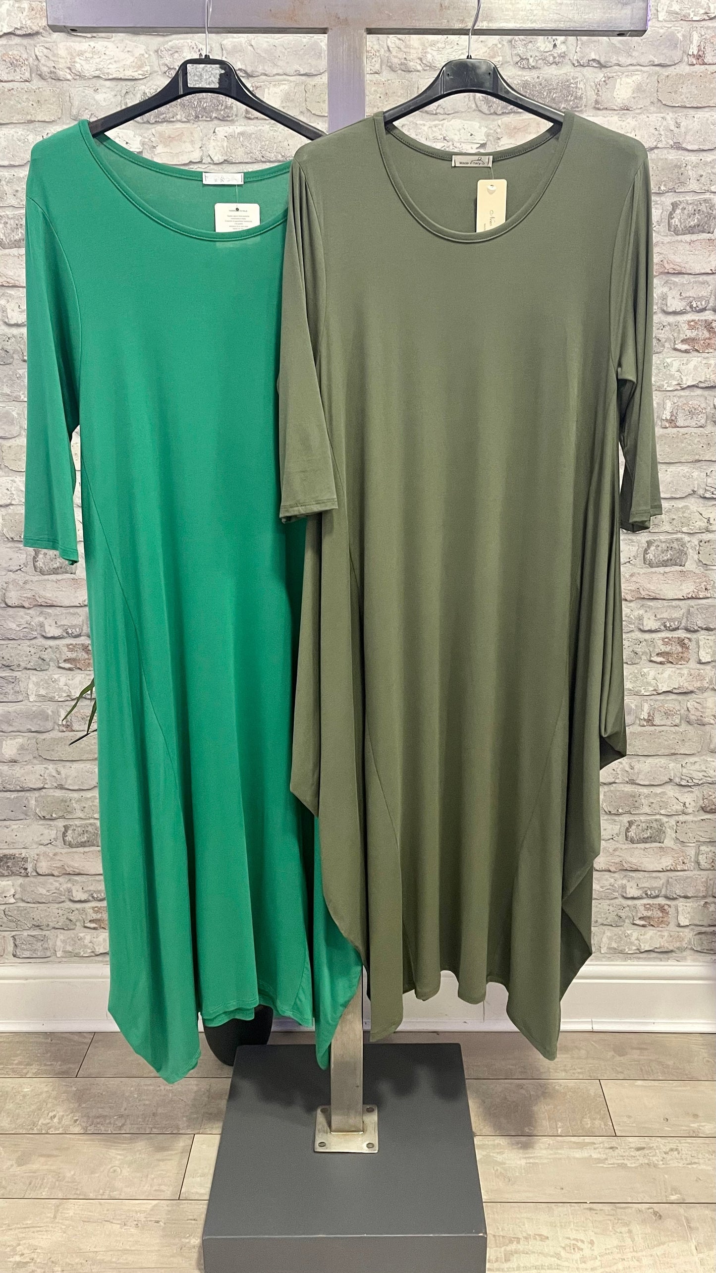Parachute Dress 3/4 Sleeve displayed in green and olive tones on hangers.