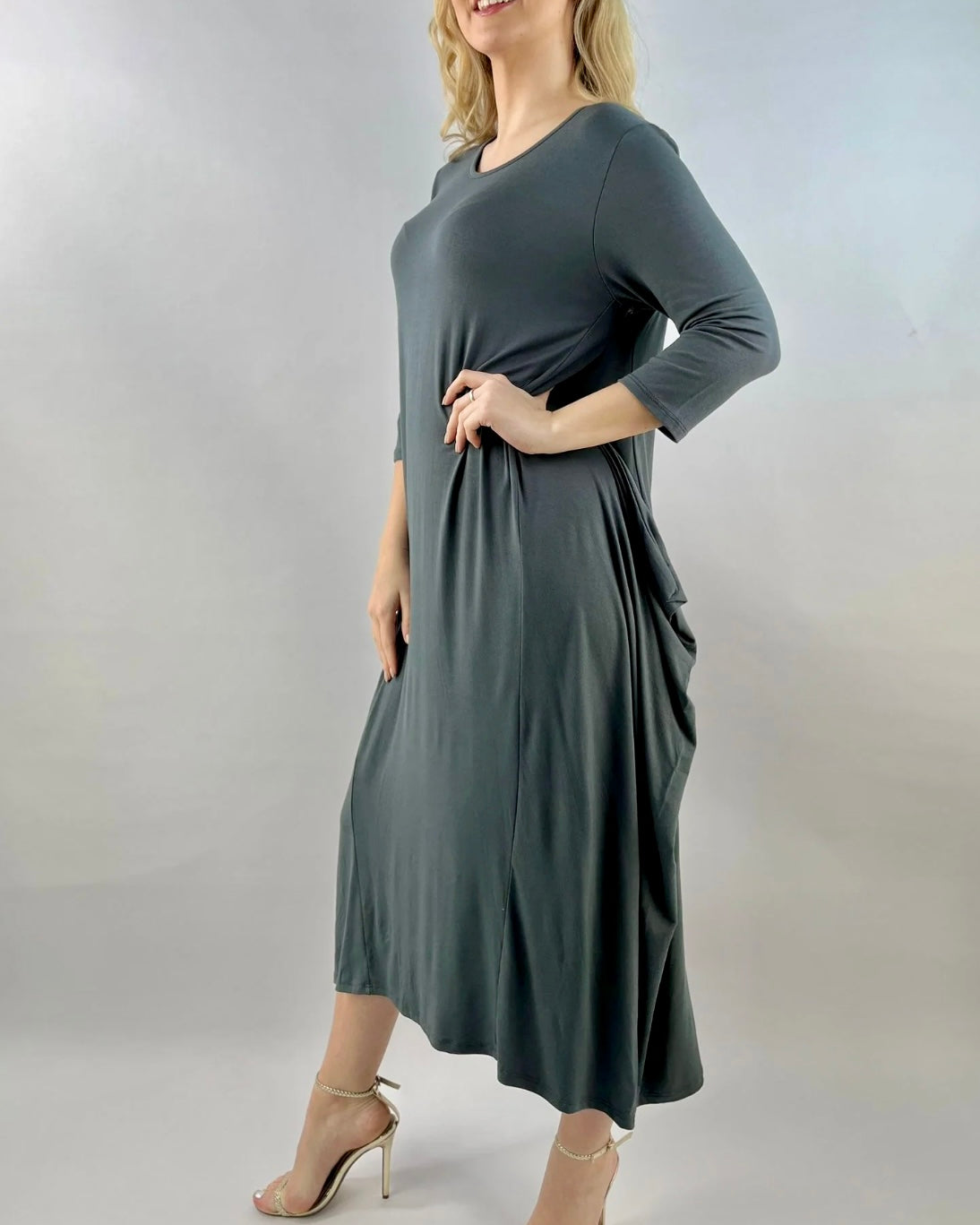 Parachute Dress 3/4 Sleeve in grey with loose fit and asymmetrical hem, 95% viscose, model wearing.