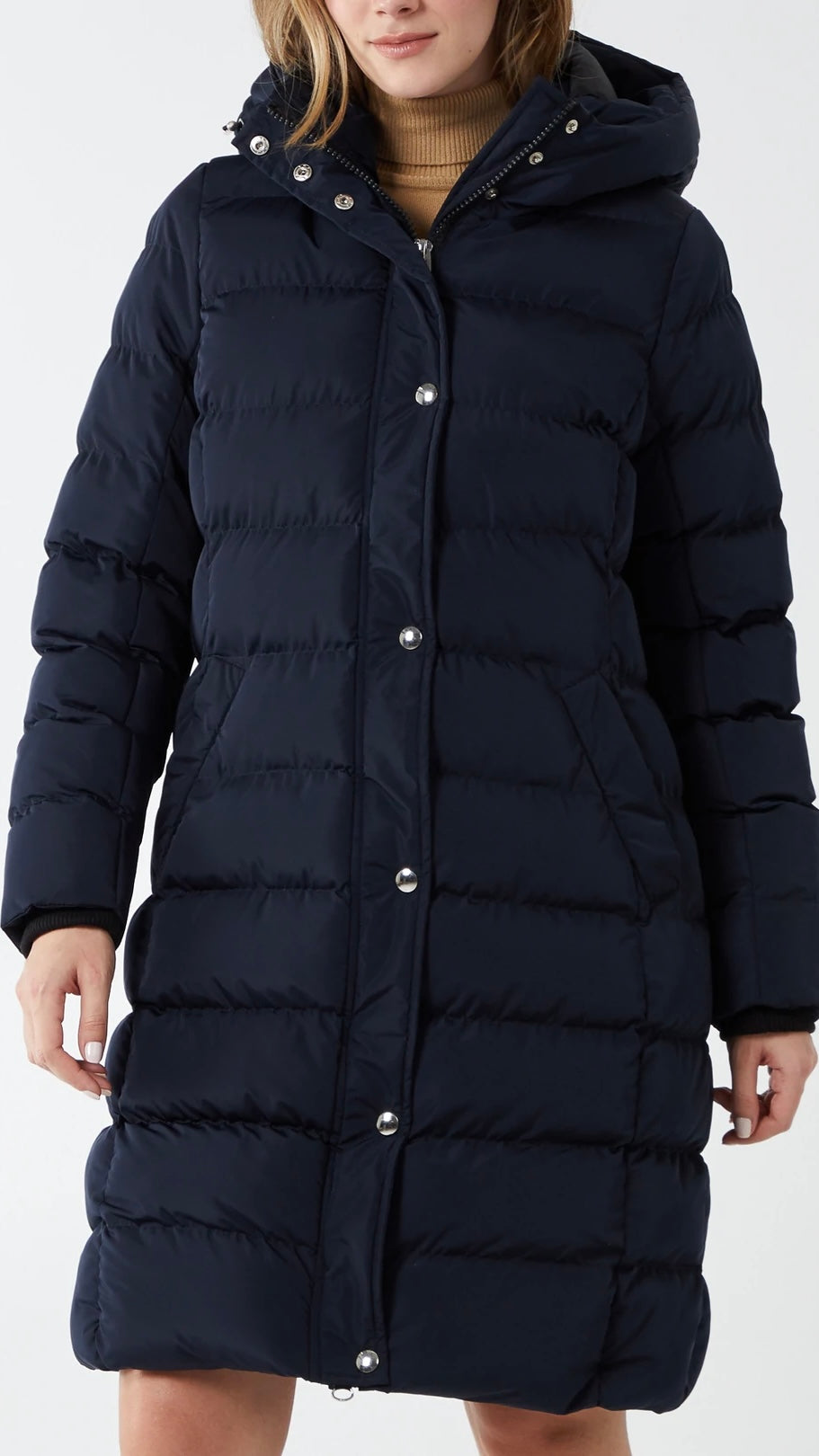 Longline puffer jacket in navy with hood, designed for warmth in high winds.