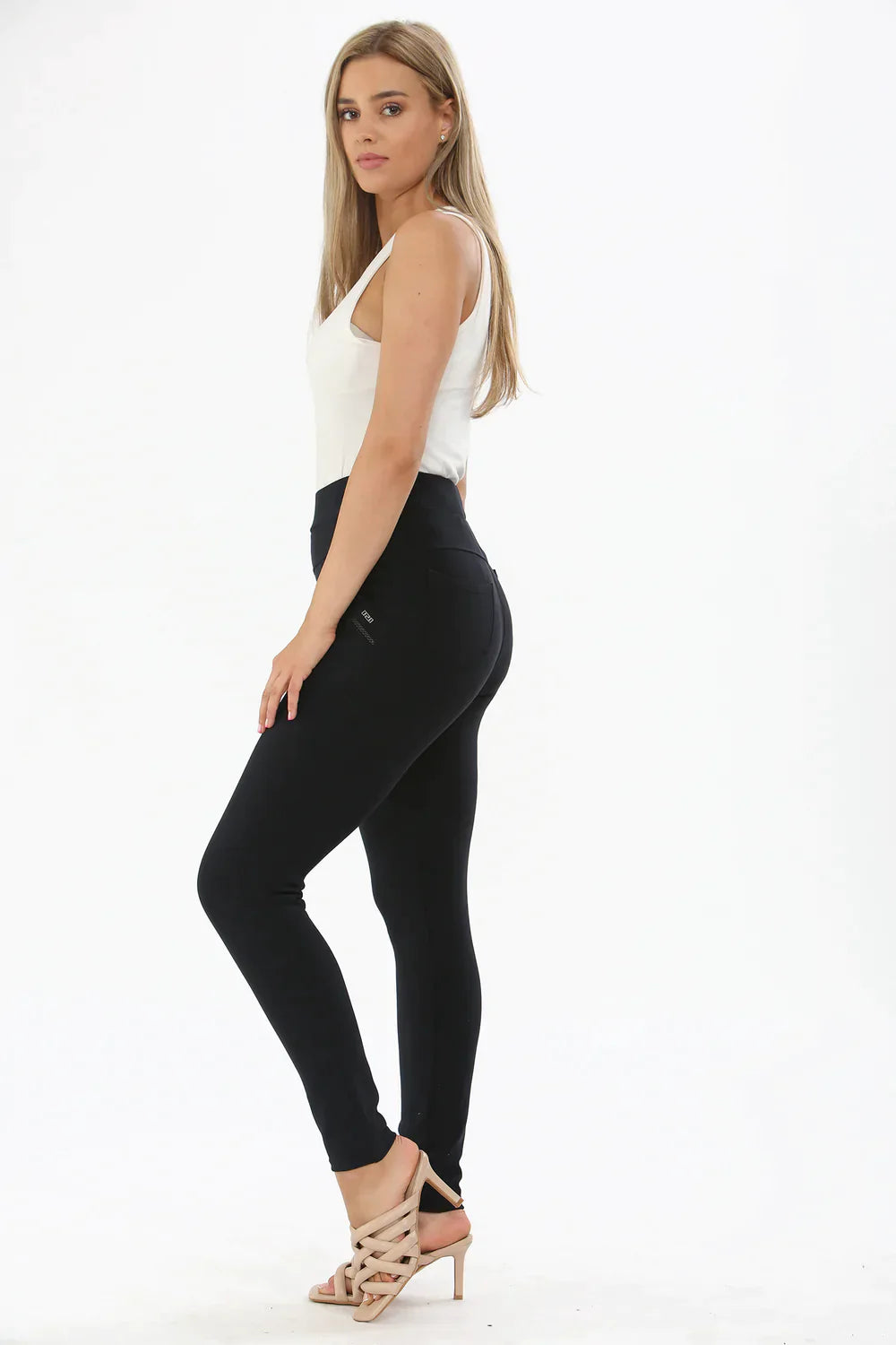 Woman wearing Navy Luxe Leggings, side view.