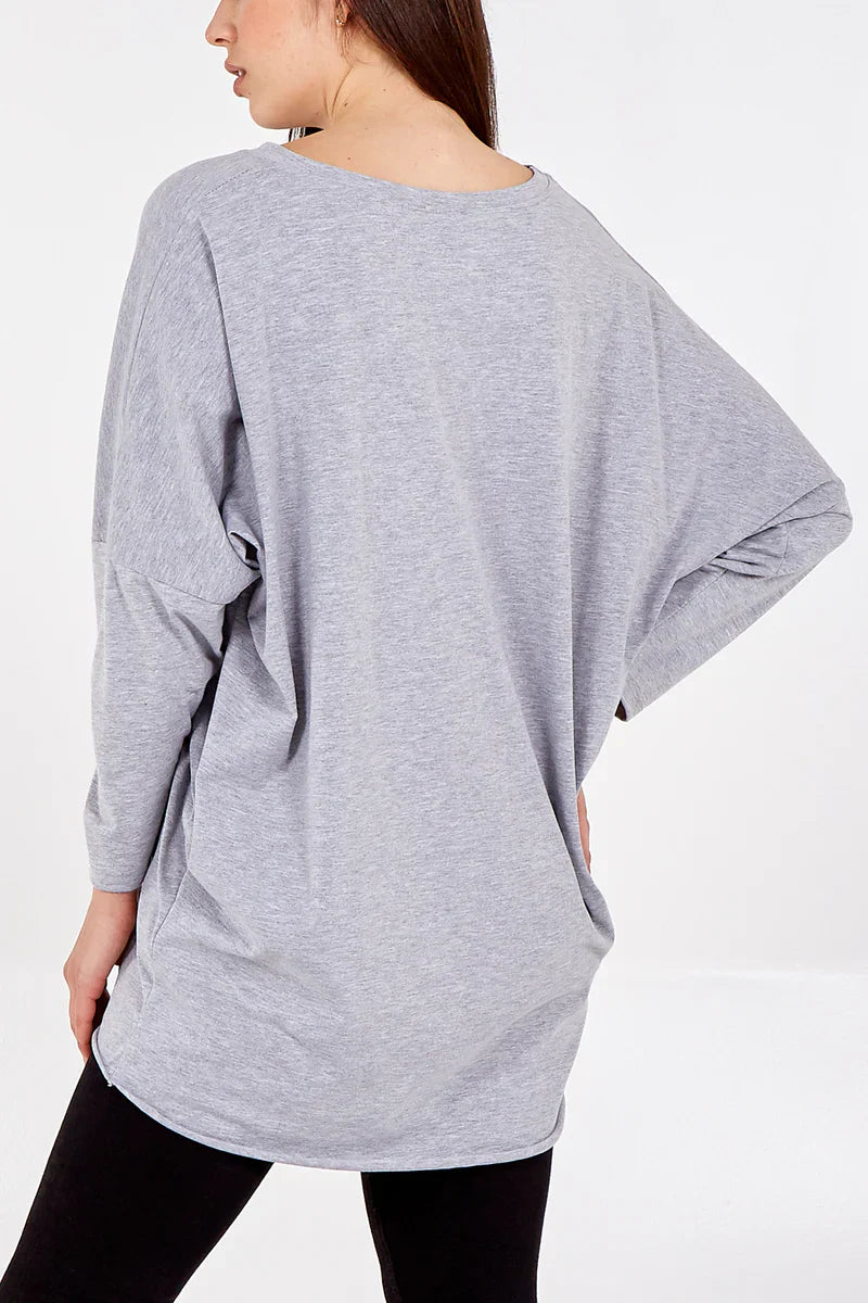 Long sleeve longline T-shirt with side pockets, relaxed fit, and extended length.