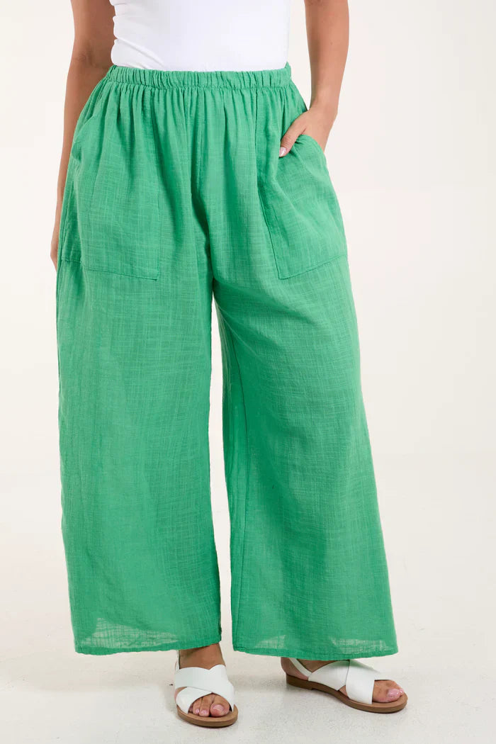 Cotton wide leg trousers in green with a relaxed fit and side pockets.