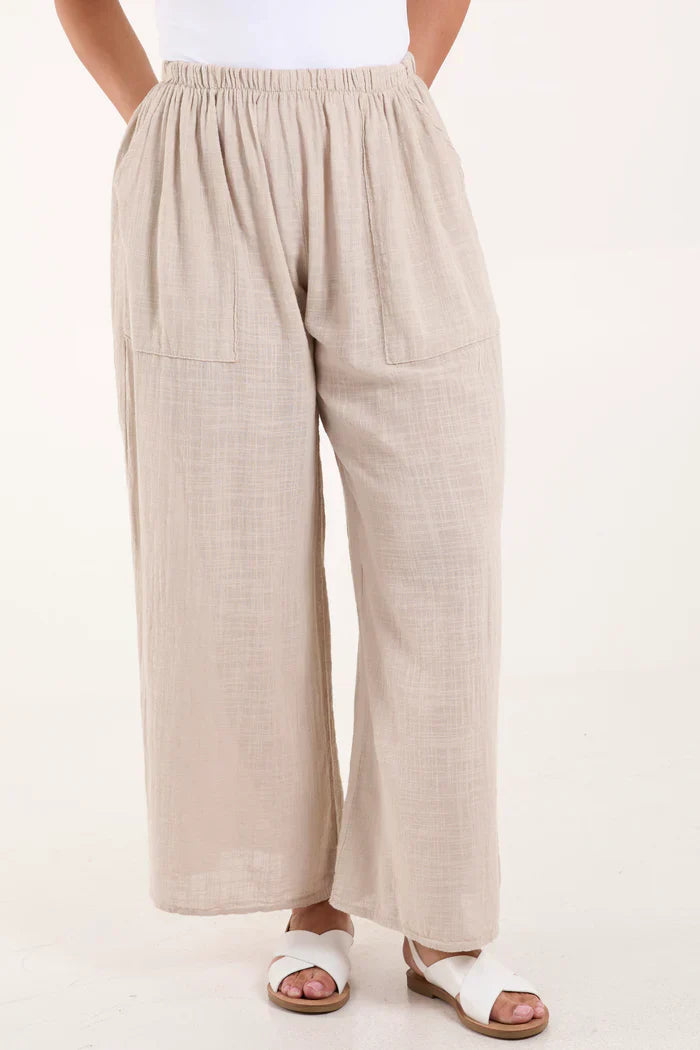 Cotton wide leg trousers, breathable fabric, relaxed fit, side pockets, shown with white sandals.