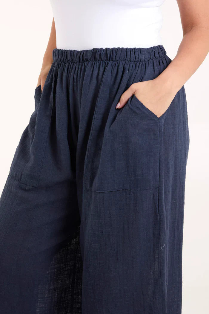 Cotton wide leg trousers with side pockets, made from 100% cotton, featuring a relaxed fit.