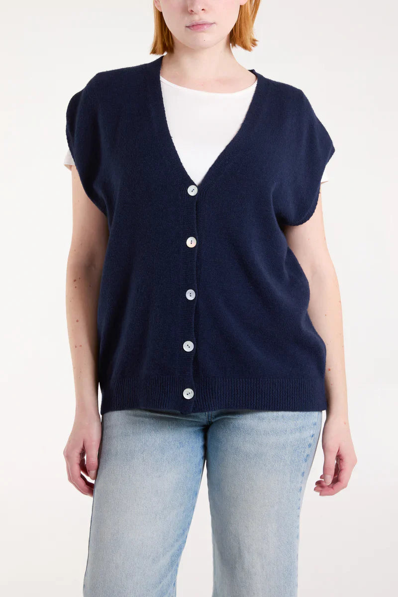 Shell Buttons Knit Vest in navy, layered over a white shirt, featuring traditional Italian design for spring.
