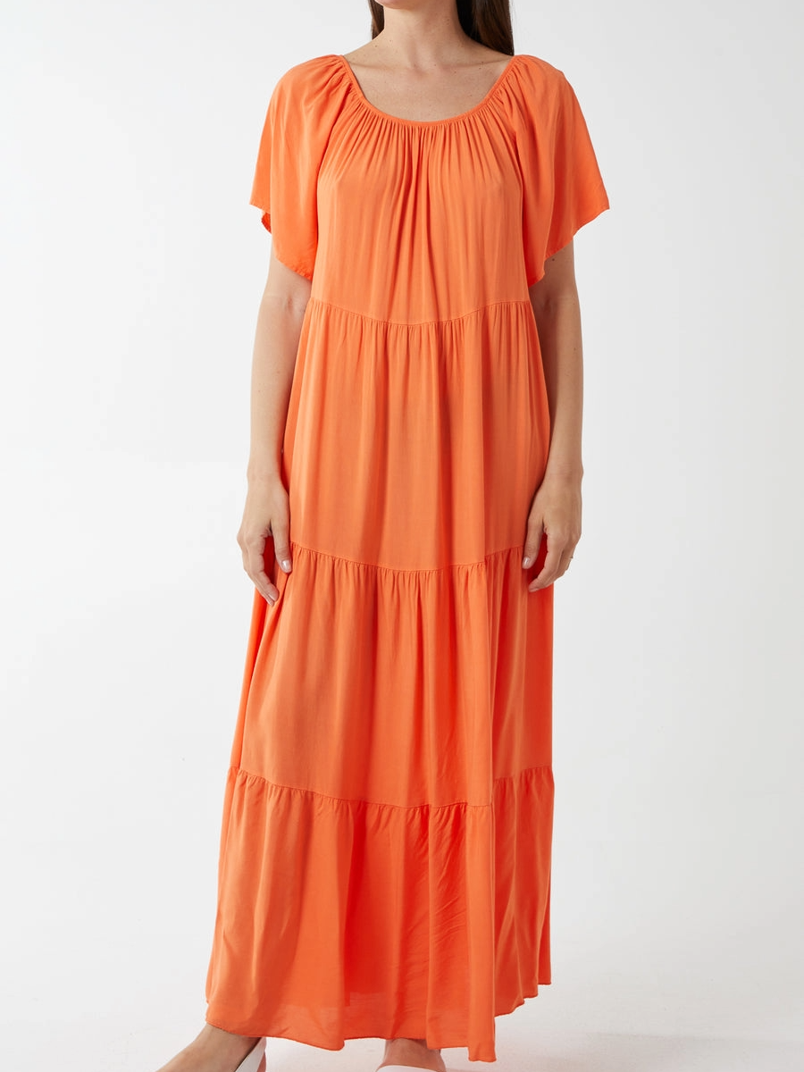 Gypsy Tiered Maxi Dress made of 100% viscose in vibrant orange.