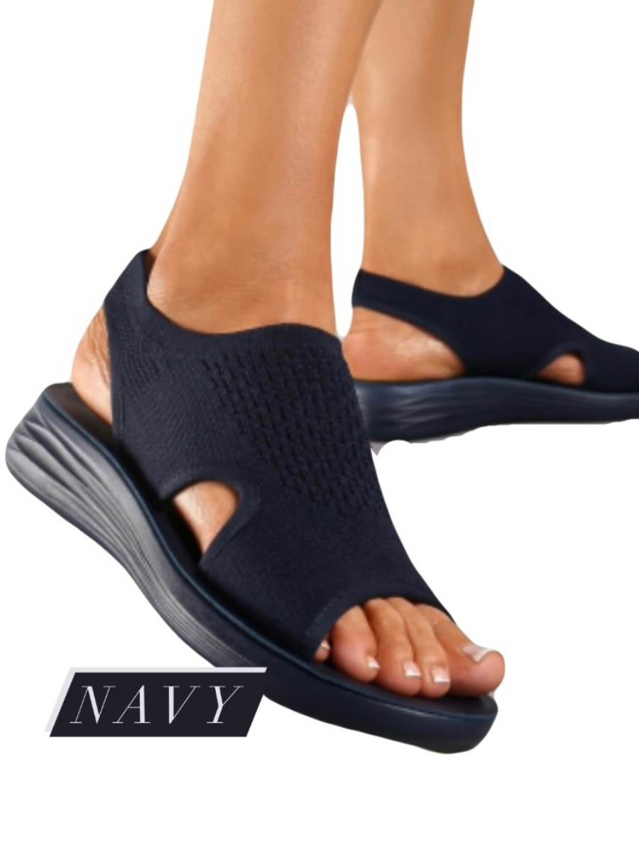 Lightweight navy comfort sandal with fabric upper and light sole for wider feet.
