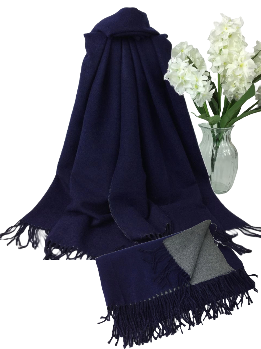 Plain soft winter scarf made of 60% viscose, 40% polyester, displayed with flowers.