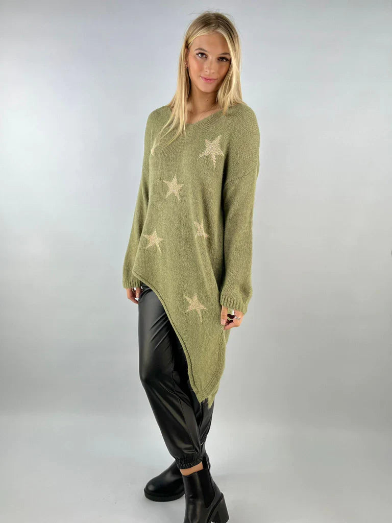 Asymmetric star jumper with bold star patterns and unique hem, perfect for casual styling.