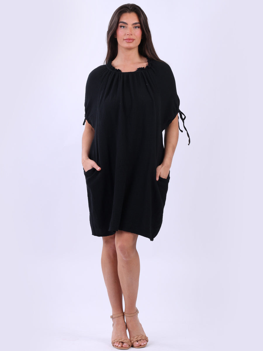 Cheesecloth Drawstring Dress with ruched neck, back tie knot, and side pockets.