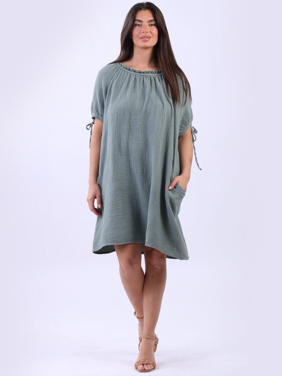 Cheesecloth Drawstring Dress with ruched neck, knotted balloon sleeves, and side pockets.