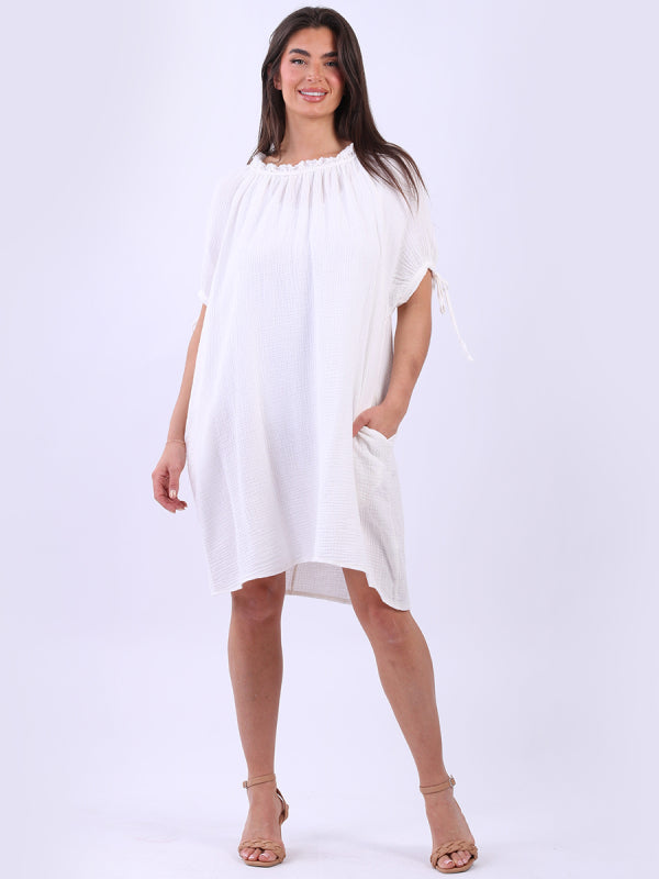Cheesecloth drawstring dress with ruched neck, knotted balloon sleeves, and side pockets.