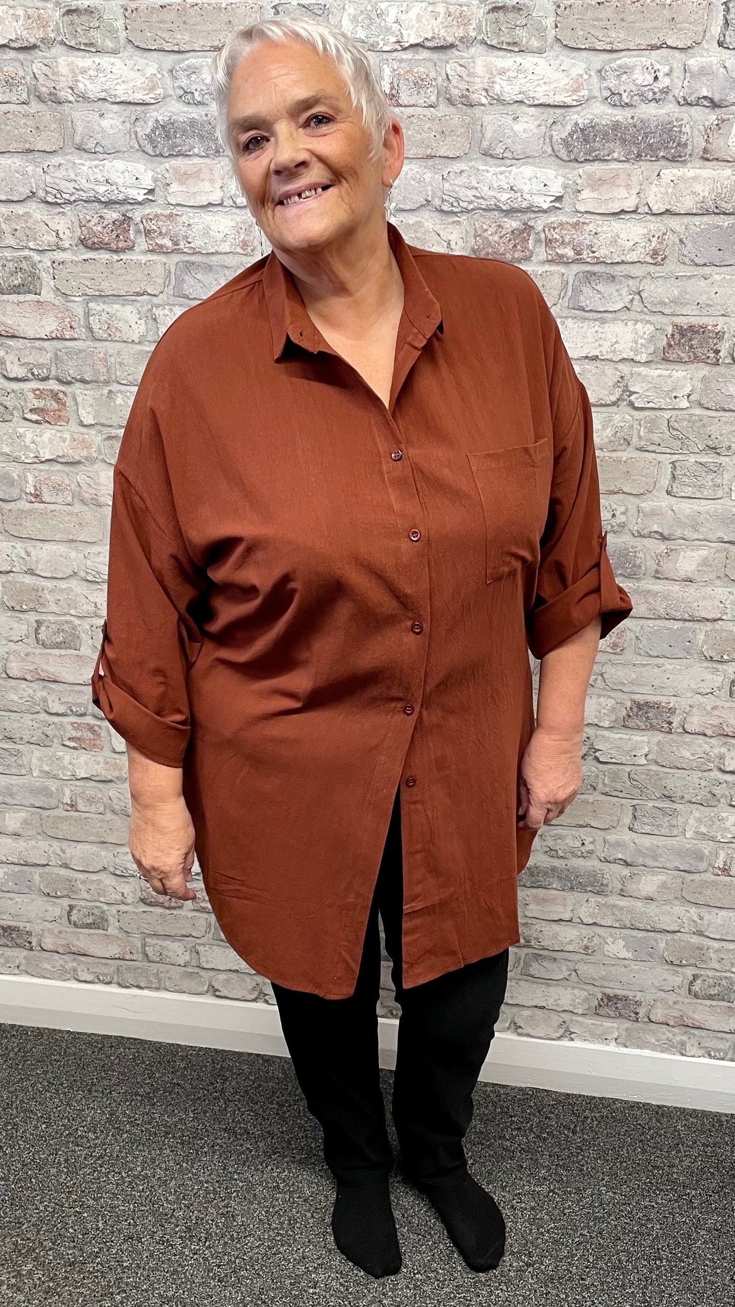 Plus size woman wearing a plain thick longline shirt in polyester.