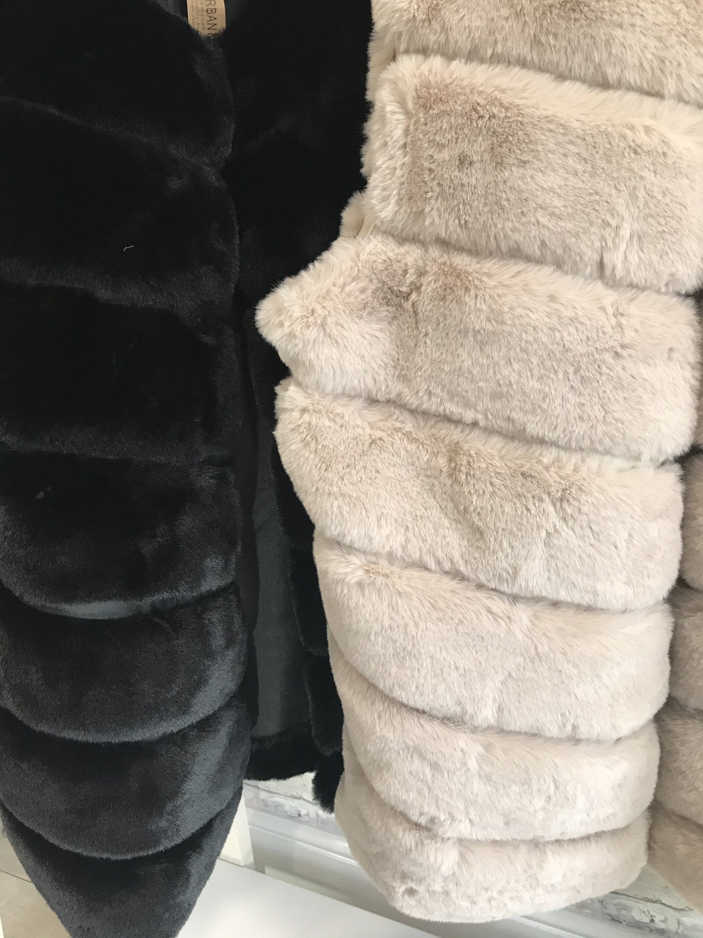 Ladies faux fur gilets with plush texture and silk-leather look lining.