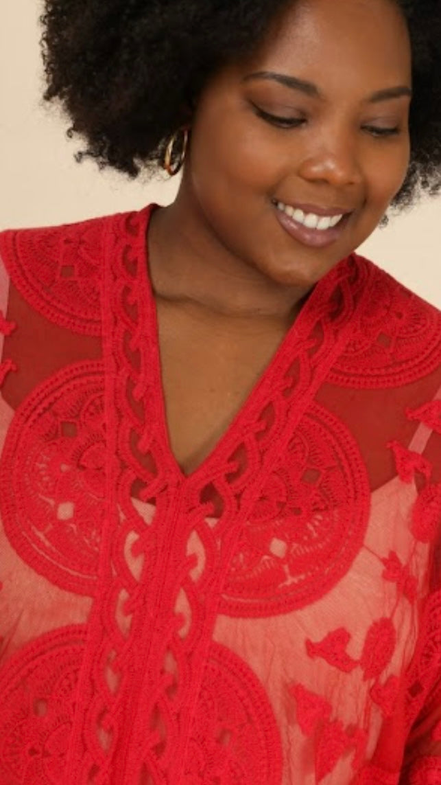 Red lace poncho with intricate patterns made of 65% cotton and 35% nylon.