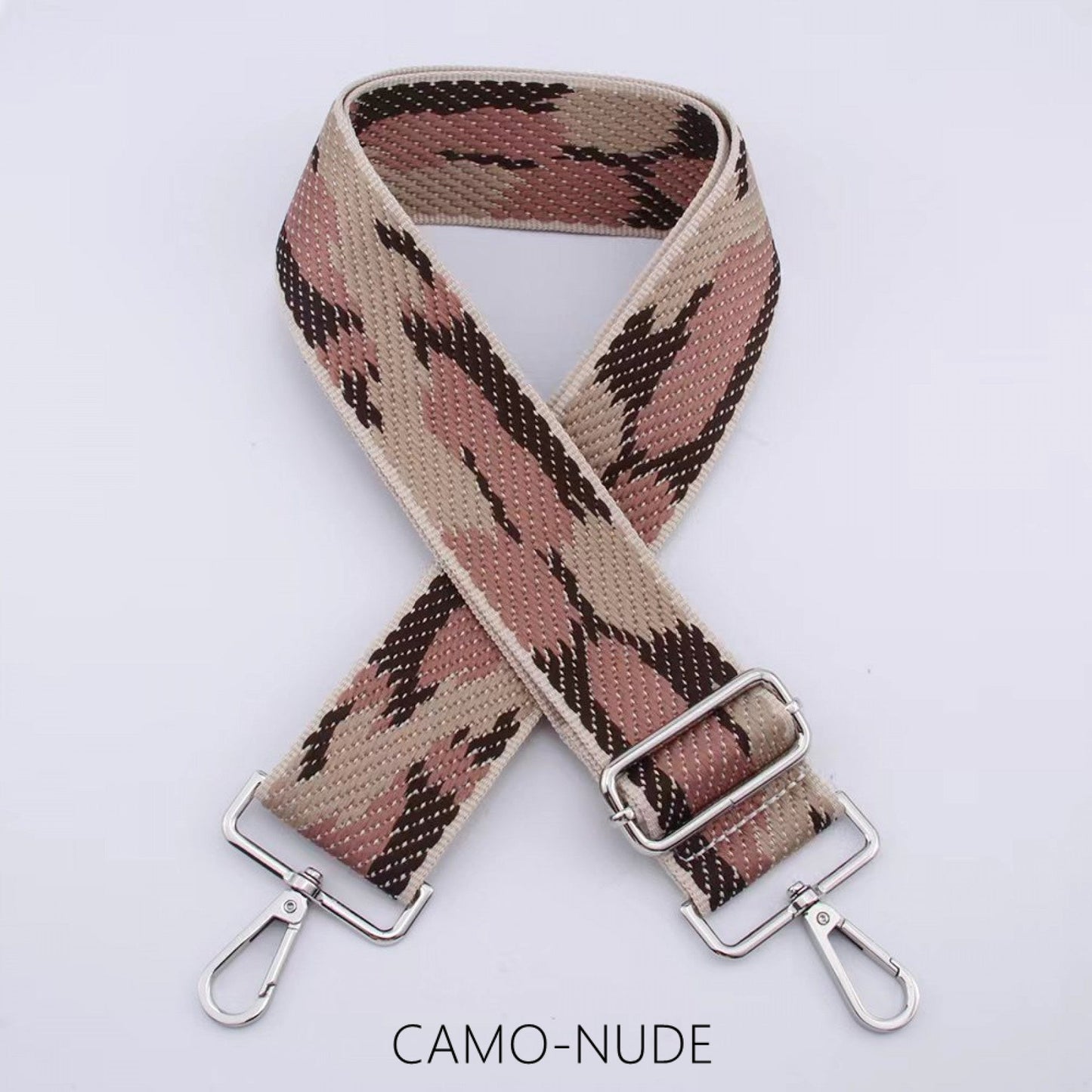 Camouflage wide bag strap with silver hardware in camo-nude pattern.