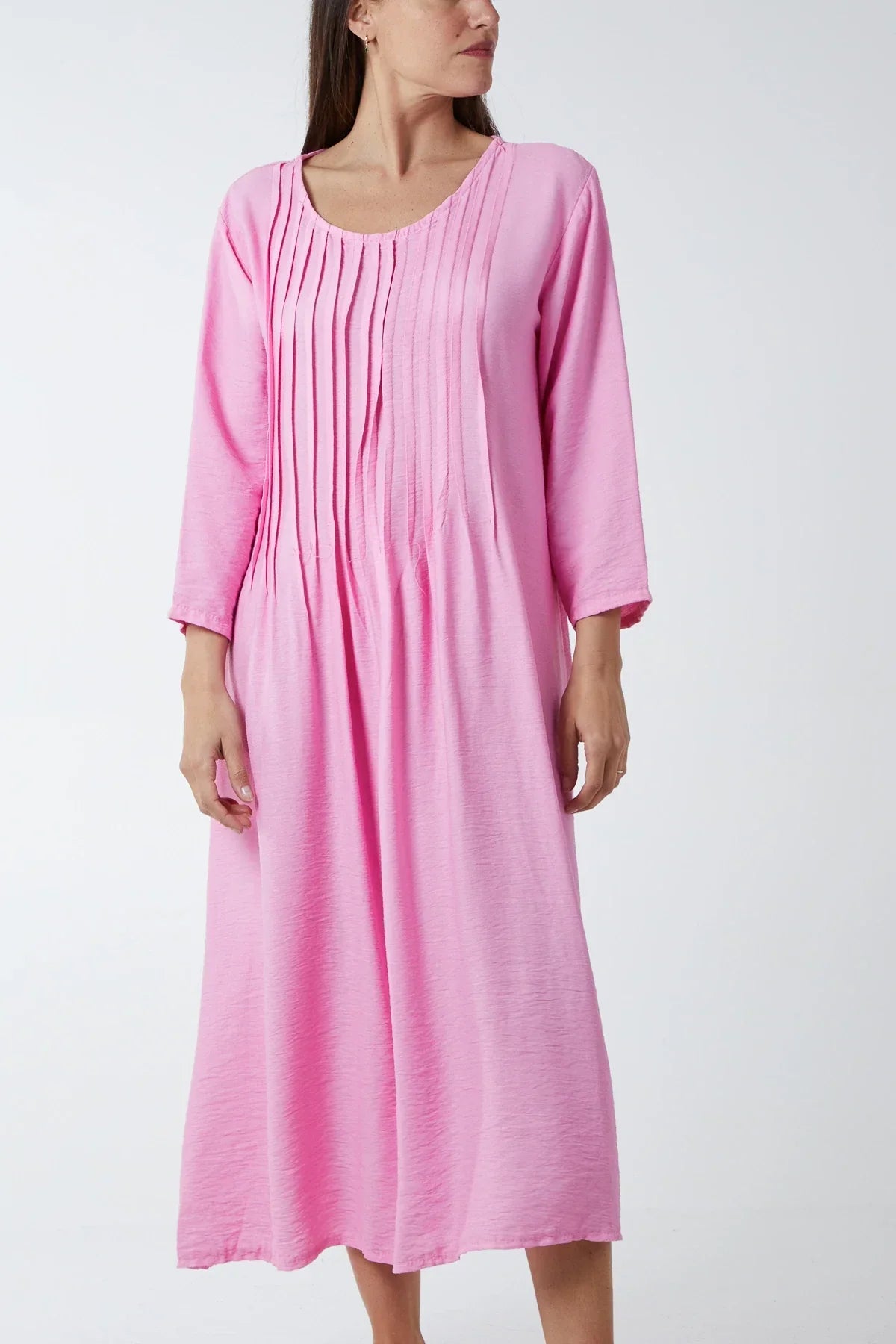 Pink pin-tuck bodice cotton dress with three-quarter sleeves.