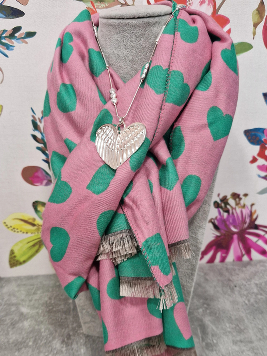 Reversible scarf with pink and green heart design, paired with a heart necklace.