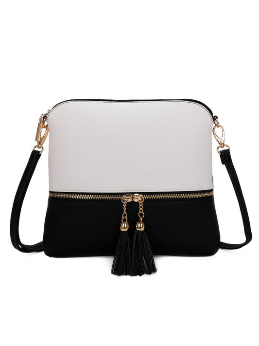 Tassel crossbody bag with gold tone hardware and adjustable strap.