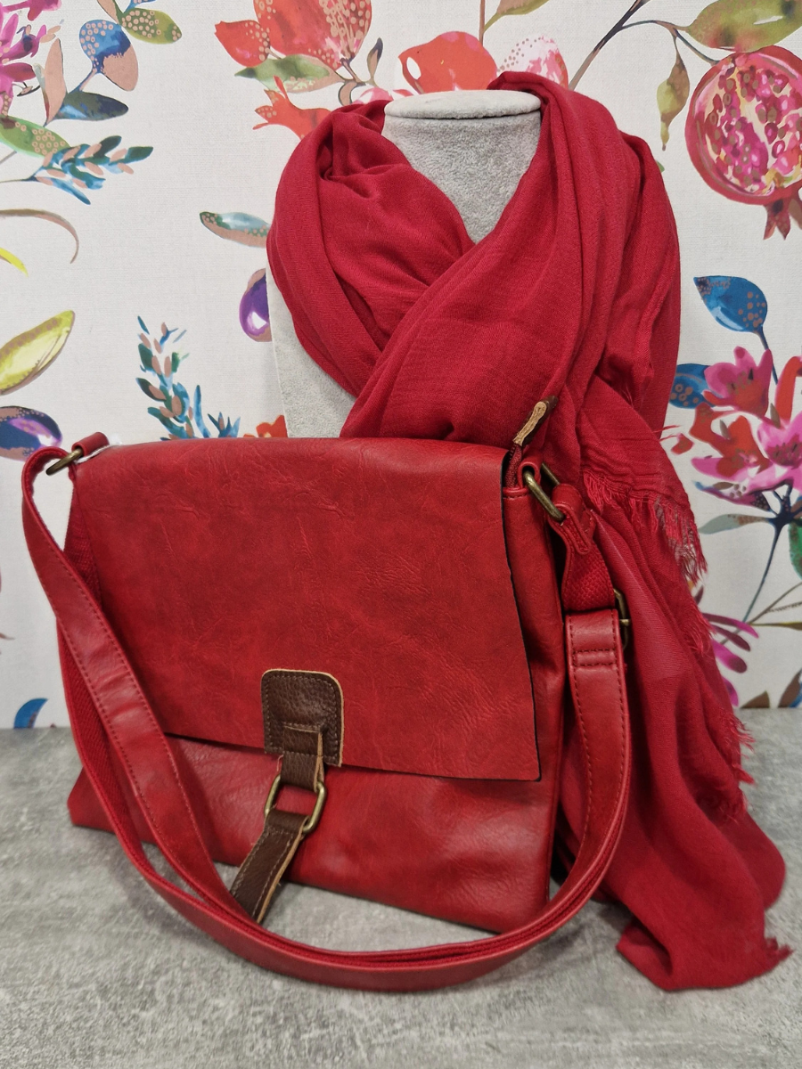 Red scarf and bag gift bundle against a floral background.