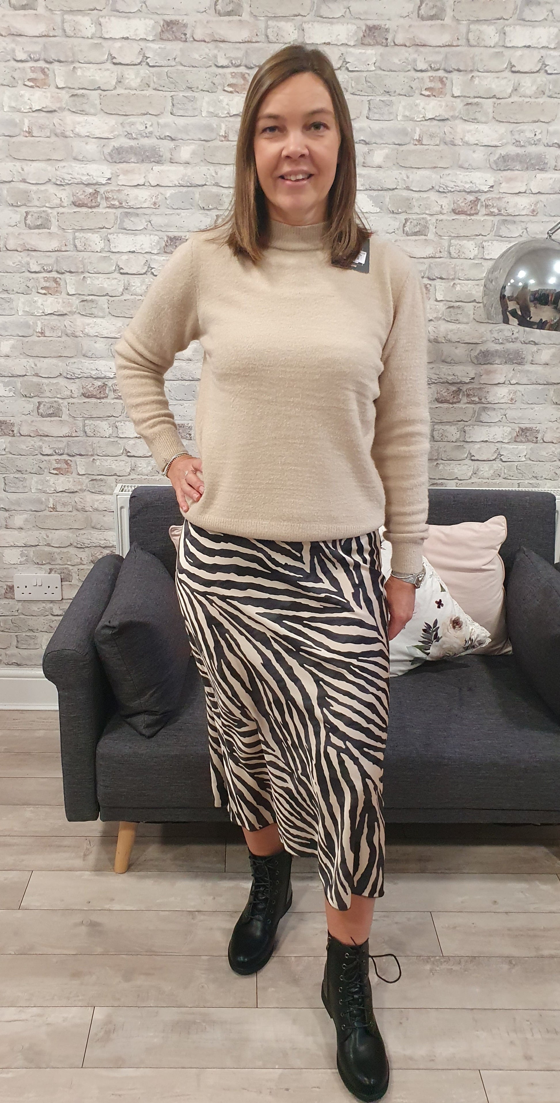 Animal print satin skirt with a zebra pattern, worn by a person pairing it with a beige top.