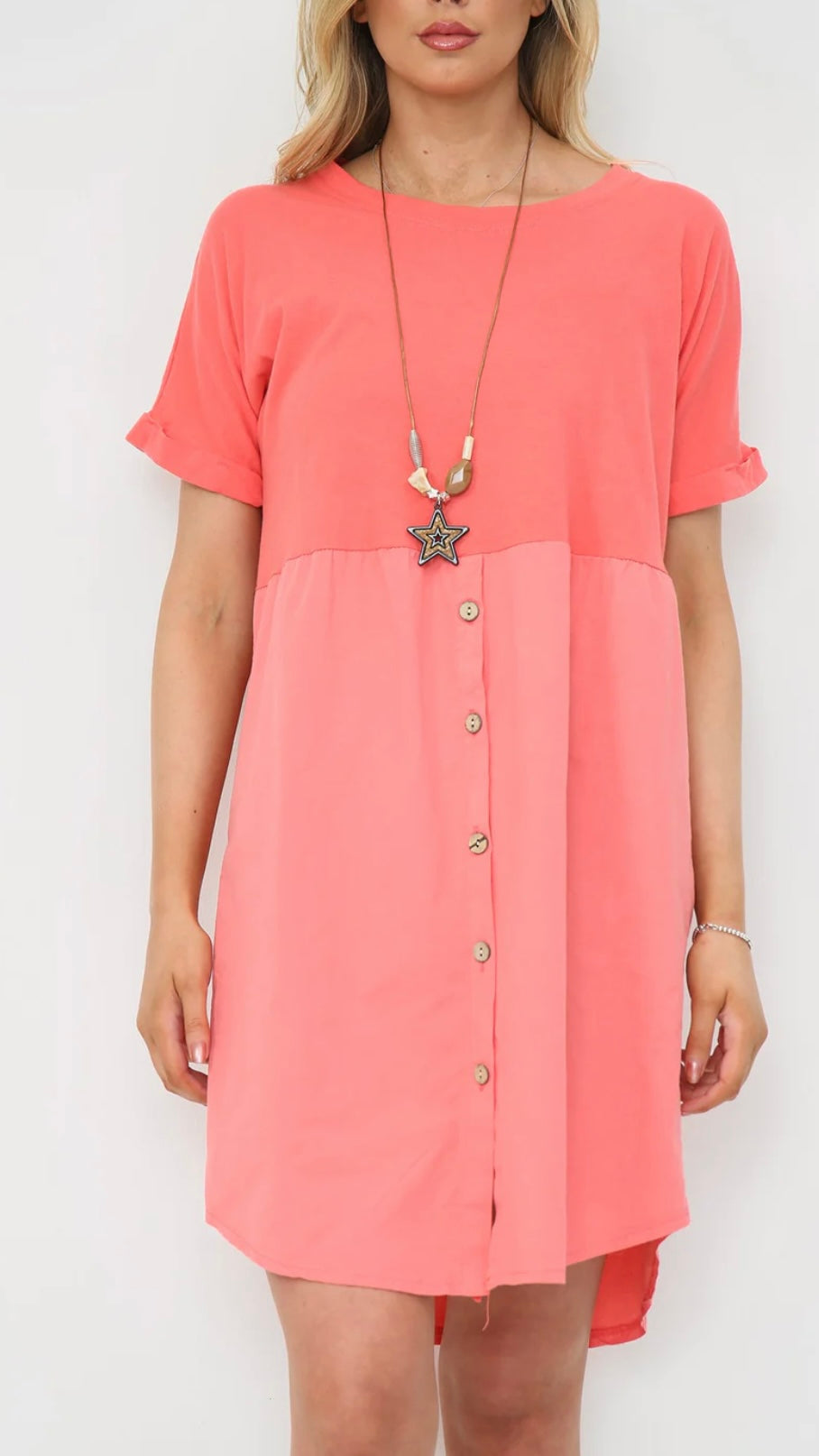 Woman wearing a button-up dress with necklace, 100% cotton.