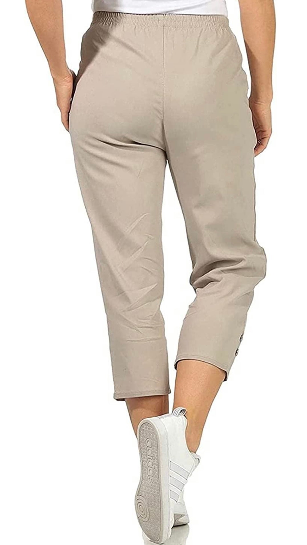 Cropped stretch trouser with button and zip pocket details and buttoned leg cuffs.