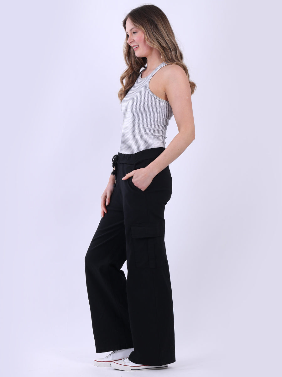 Women wearing wide leg casual magic trousers with drawstring waist and knee flap pockets.