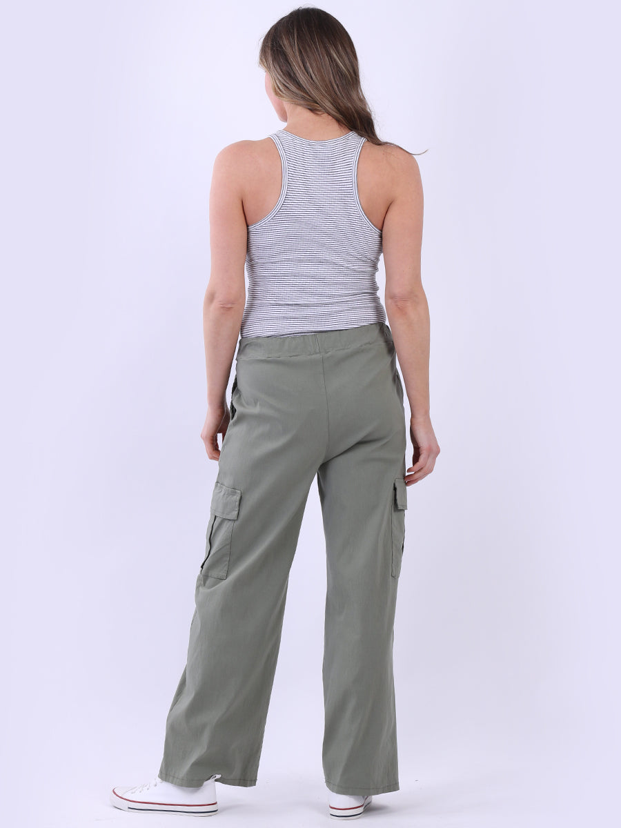 Women wearing green wide leg casual magic trousers with knee flap pockets.