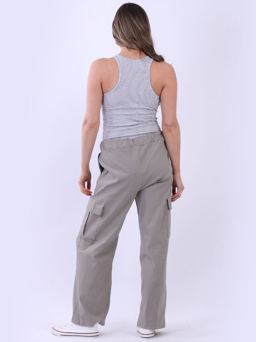 Women wearing wide leg casual magic trousers with drawstring waist and knee flap pockets.