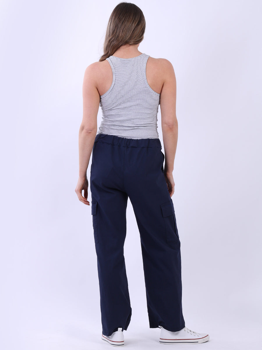 Women wearing wide leg casual magic trousers with drawstring waist and knee flap pockets.