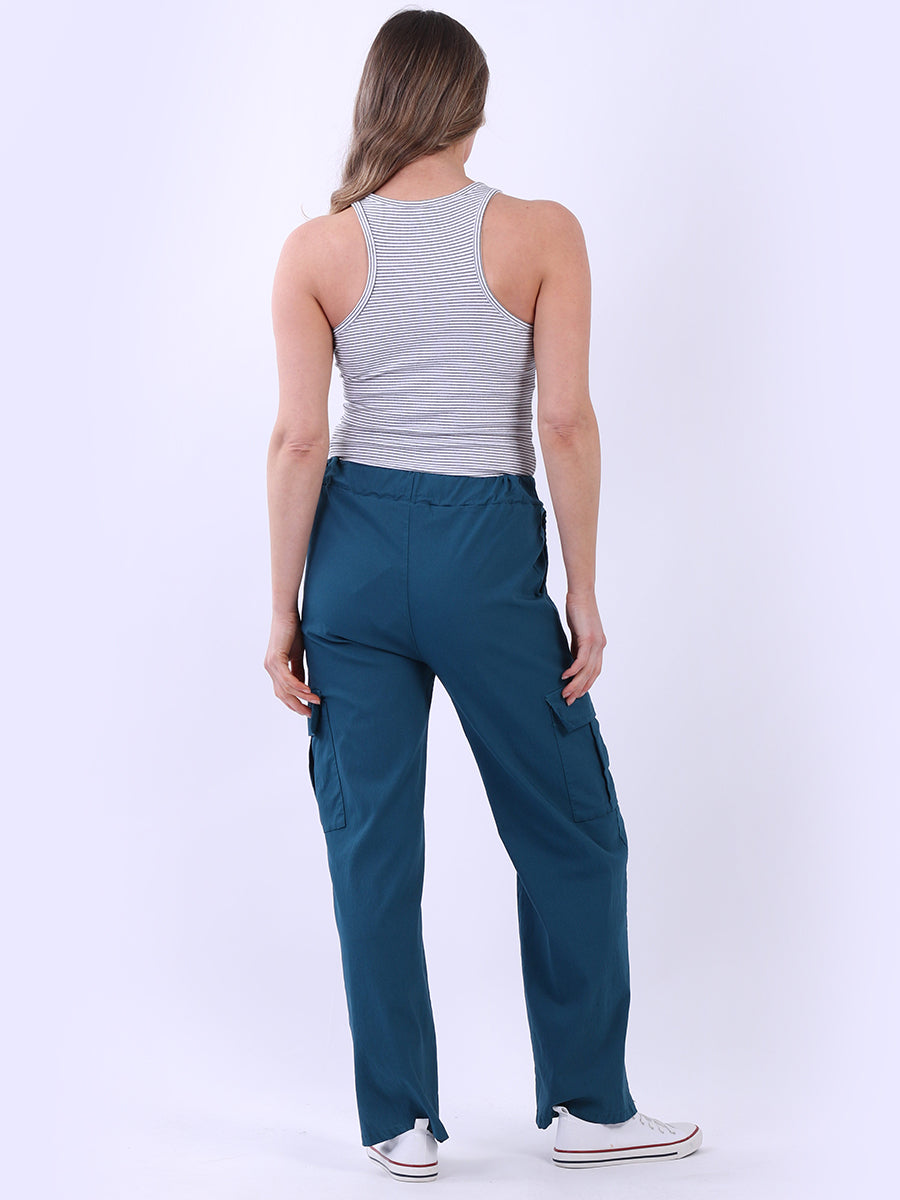 Women wearing wide leg casual magic trousers with drawstring waist and knee flap pockets.