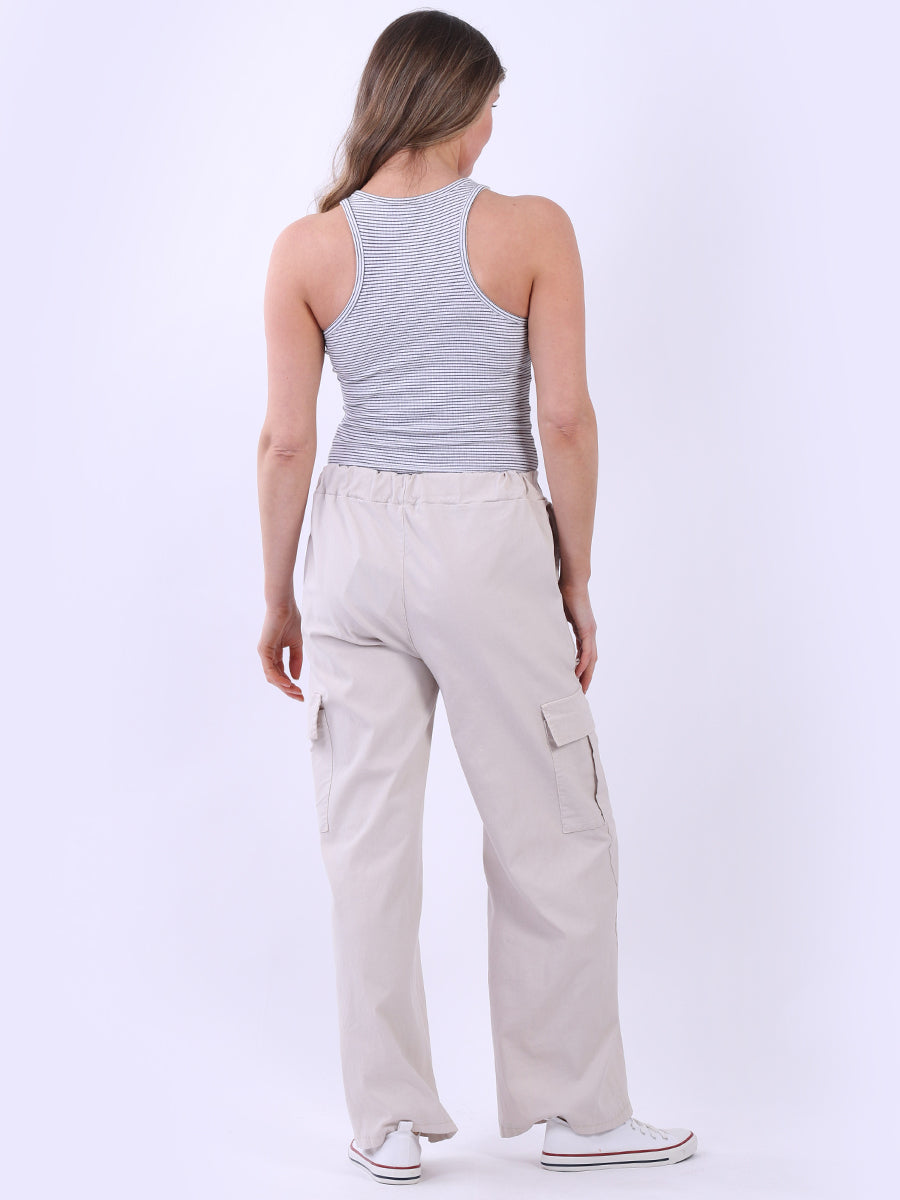 Women wearing beige wide leg casual magic trousers with drawstring waist and knee flap pockets, comfortable fit, made in Italy.