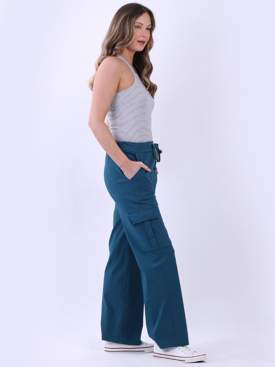 Women wearing wide leg casual magic trousers with a drawstring waist and knee flap pockets.