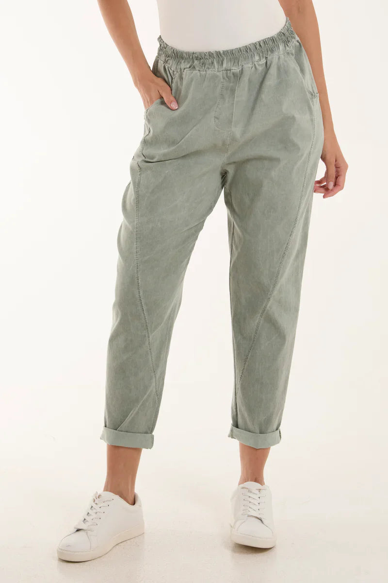 Washed relaxed fit magic trousers with vintage look worn by a person.