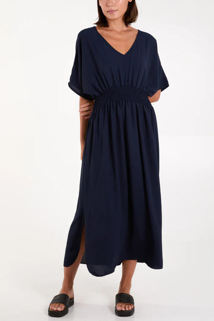 V-neck shirred waist dress in navy, 60% polyester blend fabric.