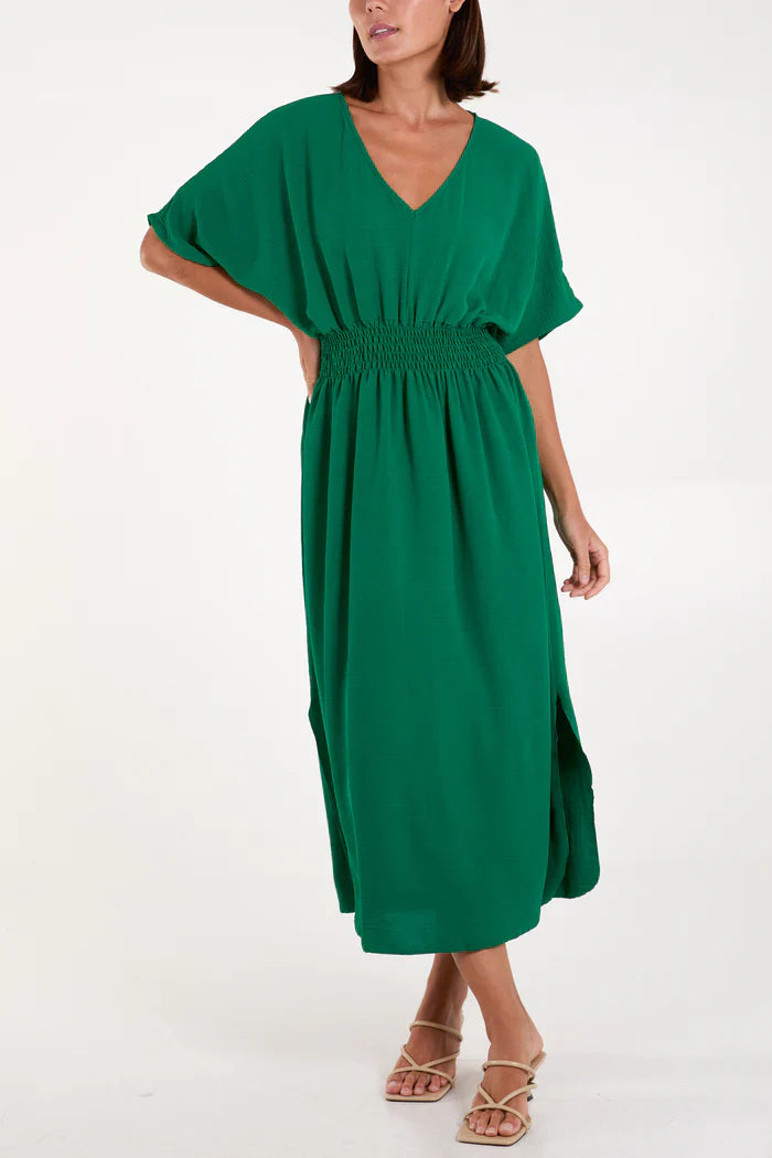 Green V-neck shirred waist dress made of polyester, viscose, and elastane.