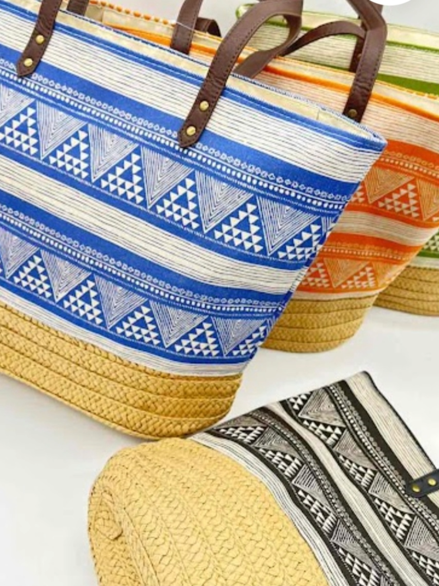 Colorful woven beach bag shoppers with geometric patterns and leather handles.